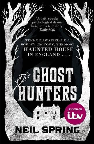 Book cover for "The Ghost Hunters" featuring a haunted house and bare trees.
