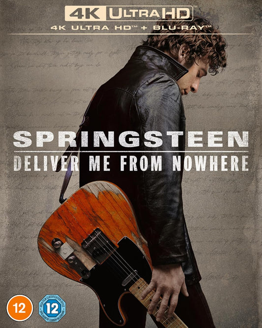 A man in a leather jacket holds a worn electric guitar against a textured background.