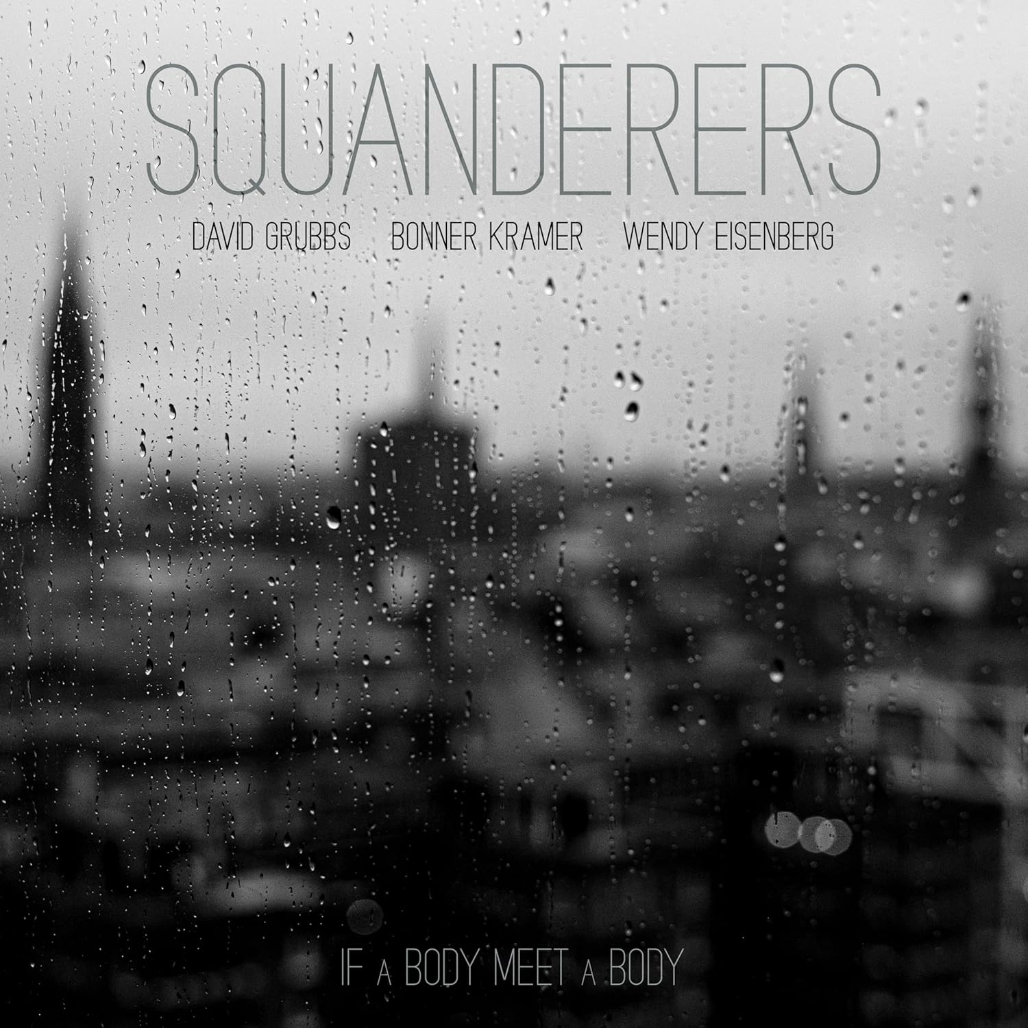 Black and white album cover showing a rainy window overlooking a blurred city skyline.