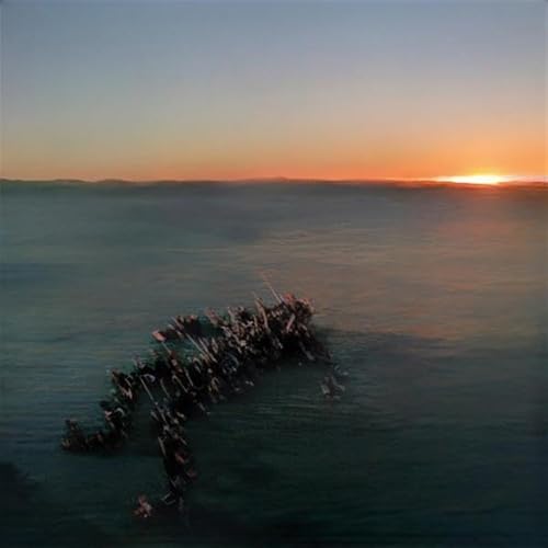 A dark, abstract shape floats on a calm sea during a sunset.