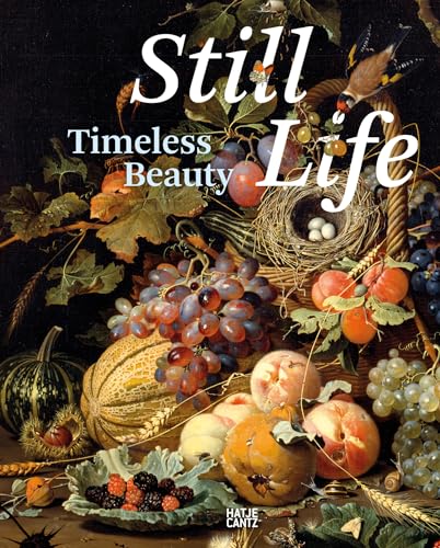 Fruit, bird’s nest, and vegetables arranged in a woven basket and on a table.