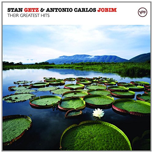 "Album cover with serene lake scene, lily pads, and mountains in the background."