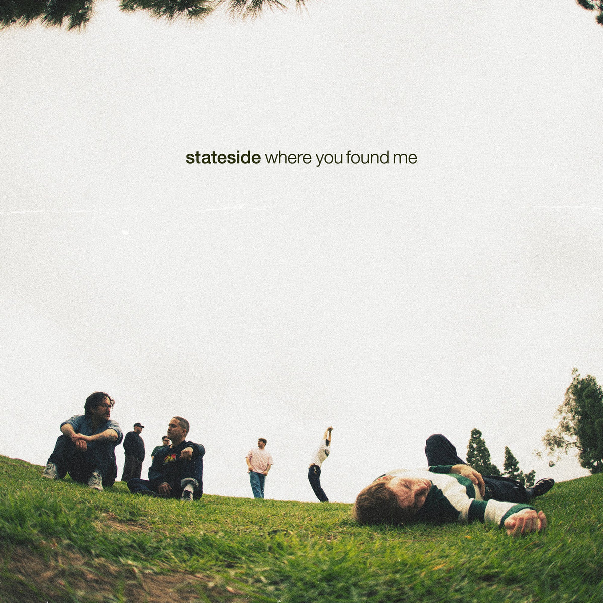 CD cover: group of people relaxing on a grassy hill.