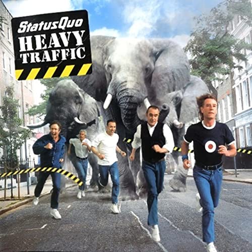CD cover: Band running from three elephants on a city street.