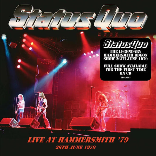 Rock band performing on stage with bright lights and fog effects.