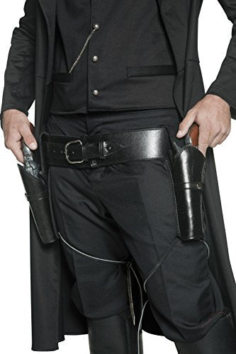 A man wearing black clothing and holsters on both thighs, holding guns in each hand.