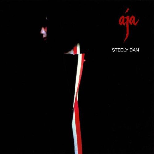 Steely Dan album cover with red and white striped pole on black background.