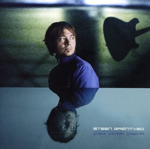 Album cover featuring a man in blue with a blurred guitar.