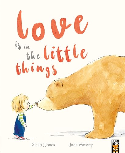 A child touches the nose of a large brown bear on a white background.