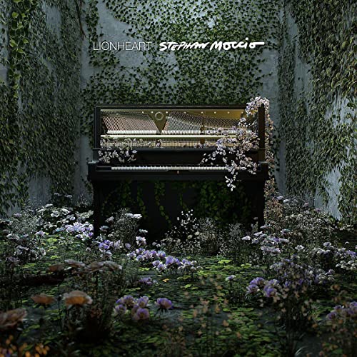 Piano surrounded by flowers and vines, album cover for Stephan Moccio’s Lionheart.