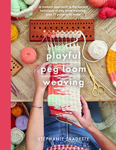 Hands weaving colorful yarn on a wooden peg loom with balls of yarn nearby.