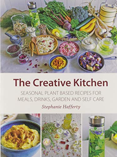 Book cover showing fresh vegetables, prepared plant-based dishes, and herbal drinks on a table.