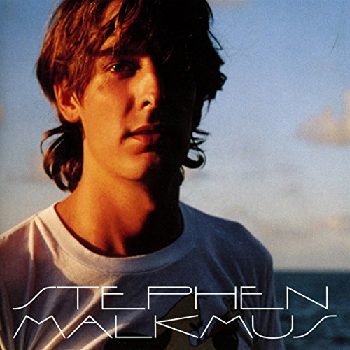 Close-up portrait of Stephen Malkmus against a blurred blue sky.