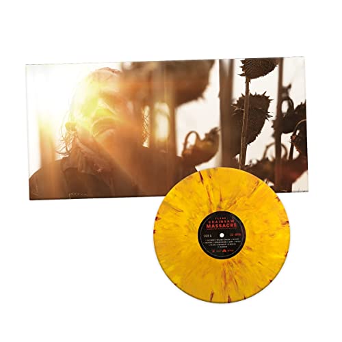 Texas Chainsaw Massacre vinyl record with yellow and red splatter pattern next to cover.