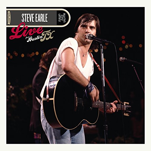 "Steve Earle on stage, playing guitar and singing into a microphone."