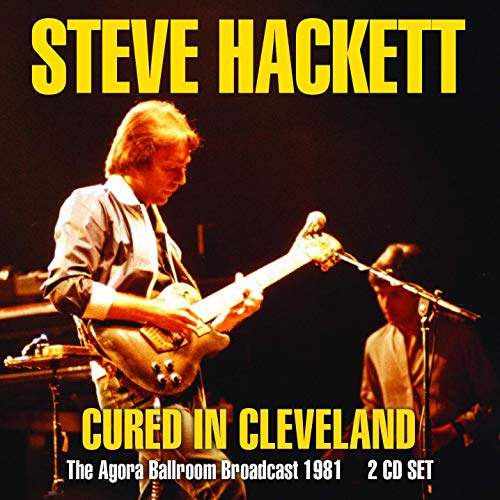 "Album cover featuring a man playing guitar on stage with another musician."