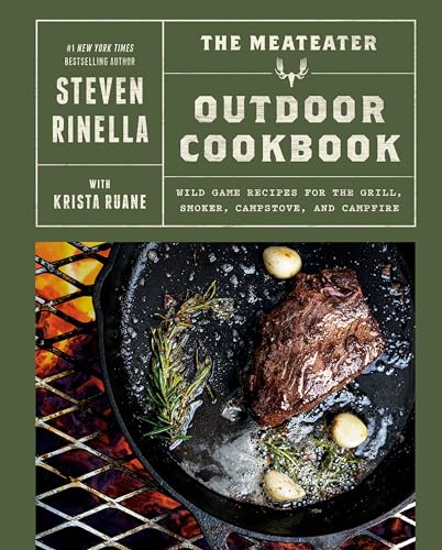 Book cover for The MeatEater Outdoor Cookbook showing a steak cooking in a skillet.