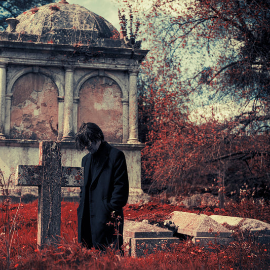 CD cover: man in black coat stands in a graveyard.