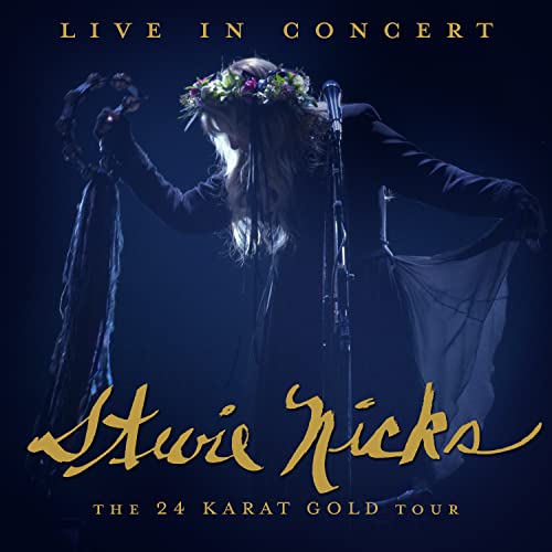 Stevie Nicks in concert, wearing a floral crown and flowing fabrics.