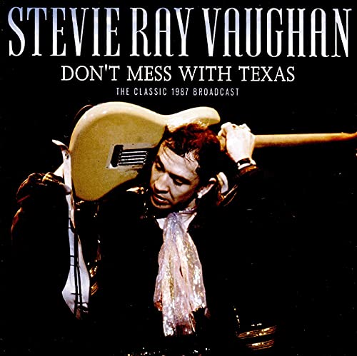 Stevie Ray Vaughan album cover featuring him playing a guitar.