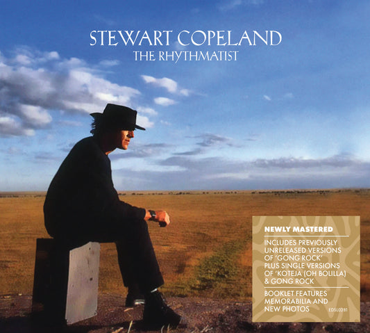 Stewart Copeland album cover: man in hat sitting in a field.