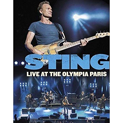 Sting playing bass guitar on stage at a live concert, Paris.