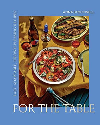 Cookbook cover with food, wine glasses, and the title “For the Table.”