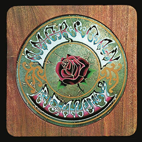 Round album cover with a rose, ornate lettering, and woodgrain border.