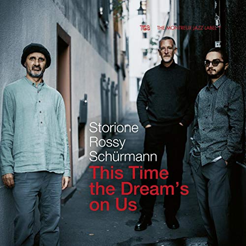 CD cover featuring three men standing in a narrow alleyway.
