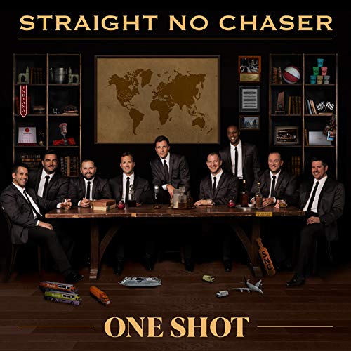 A cappella group Straight No Chaser poses around a table with a world map.