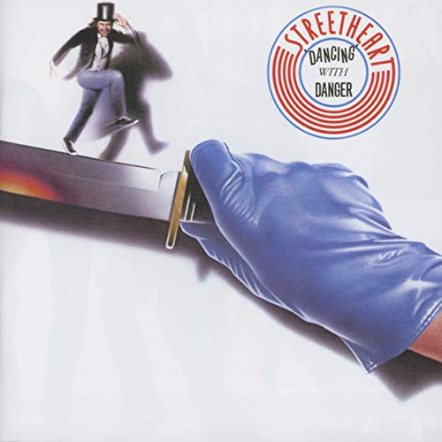 Album cover: man on a razor, large blue gloved hand.