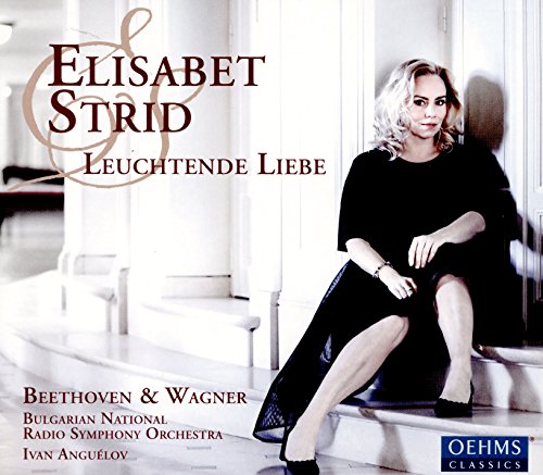 "Album cover featuring a blonde woman in black dress sitting on white stairs."