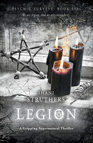 Book cover with burning candles, a twig star, and a pentagram.