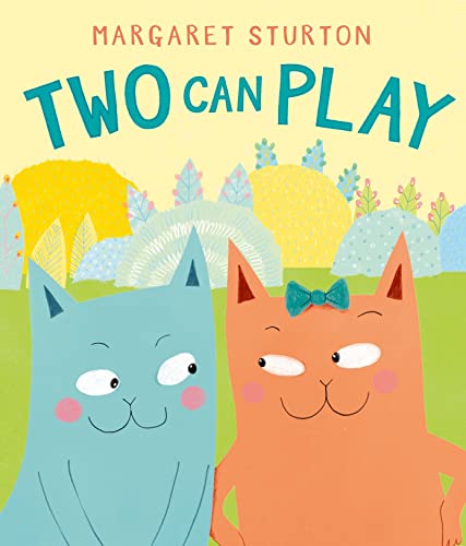 A blue cat and an orange cat with a bow stand in a garden.