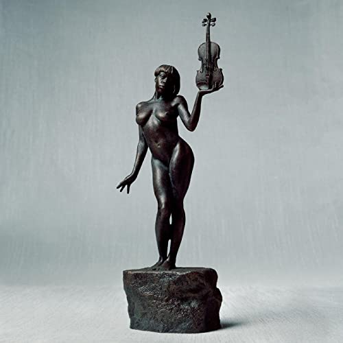 A bronze statue of a nude woman standing on a rock holding a violin.