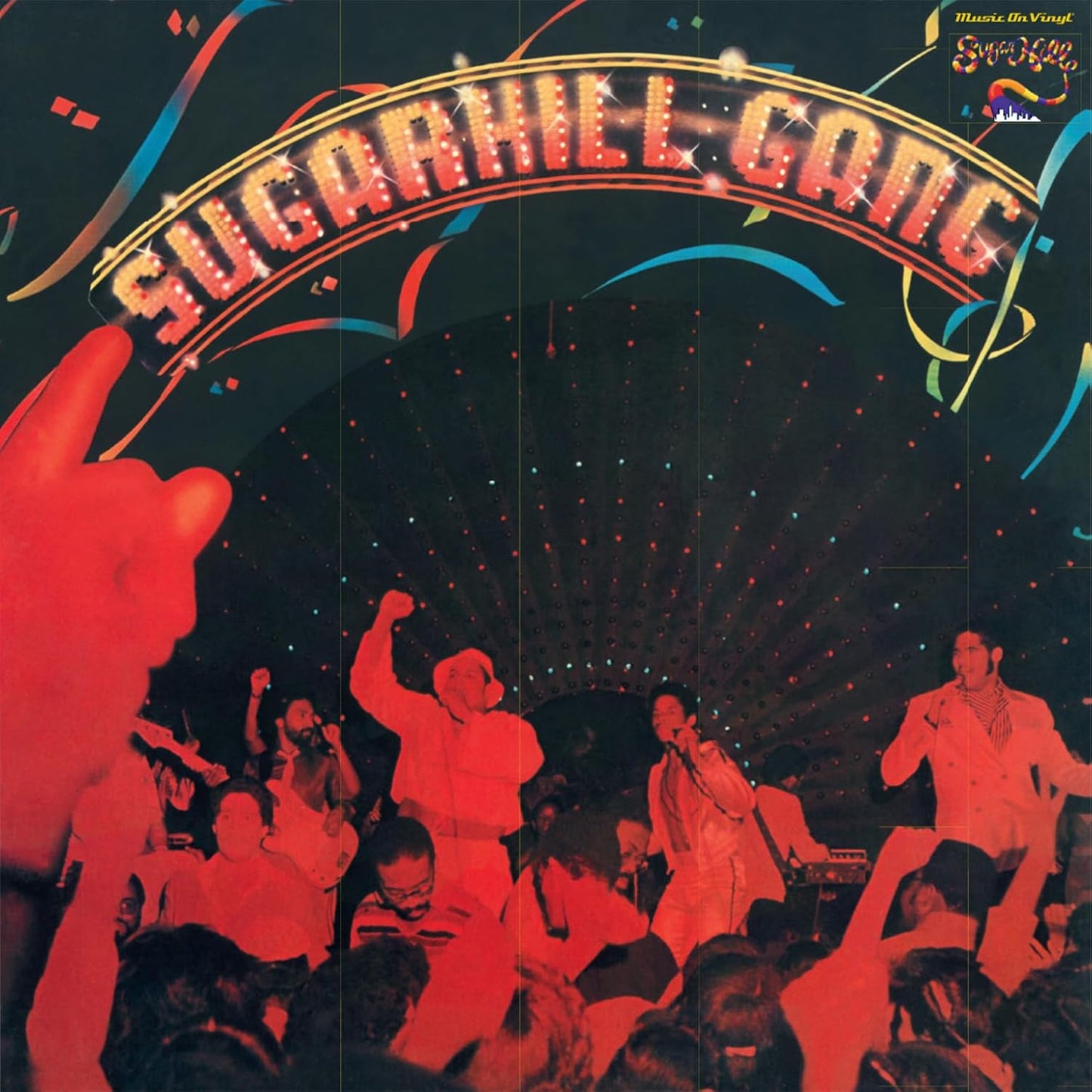Sugarhill Gang album cover with performers on stage and a blue background.