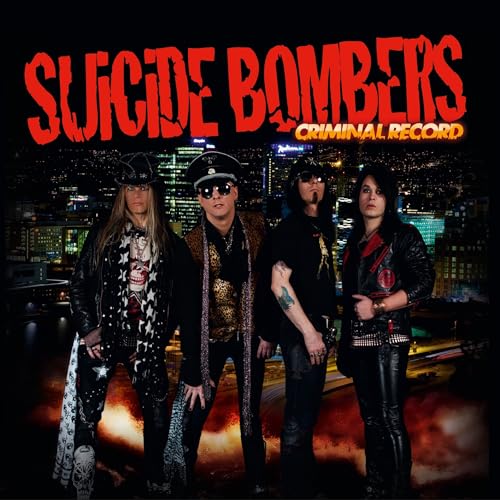Four band members in rock attire stand before a city skyline at night.