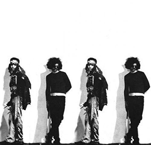 Black and white photo of four people with long, curly hair.