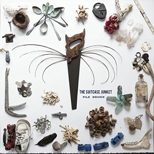 "Album cover with assorted objects and a saw resembling a cat's face."