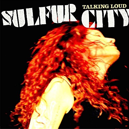 Woman with long curly red hair on black background with white and yellow text.