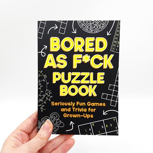 Black puzzle book with yellow text reading "Bored As F*ck Puzzle Book.