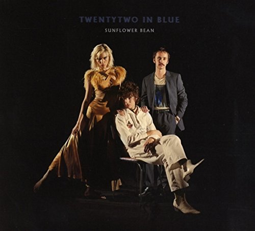 Three people posing against a black background, a music album cover.
