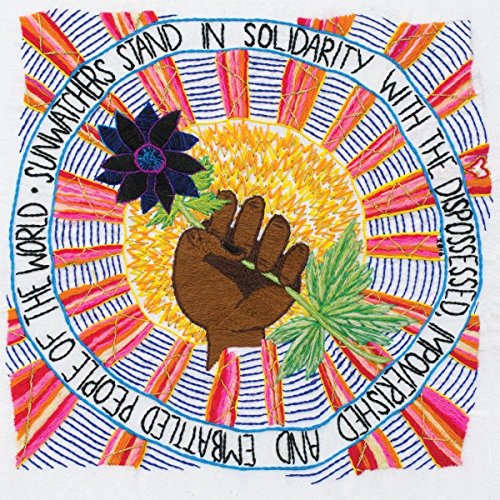 Embroidered CD cover with a sun, hand, flower, and text in a circle.