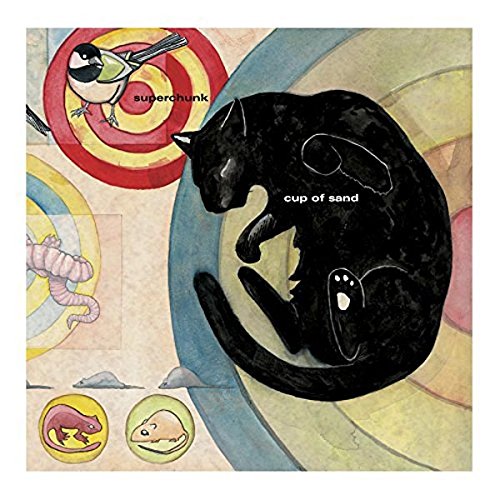 A black cat sleeps on a background of colorful circles, birds, and small animals.