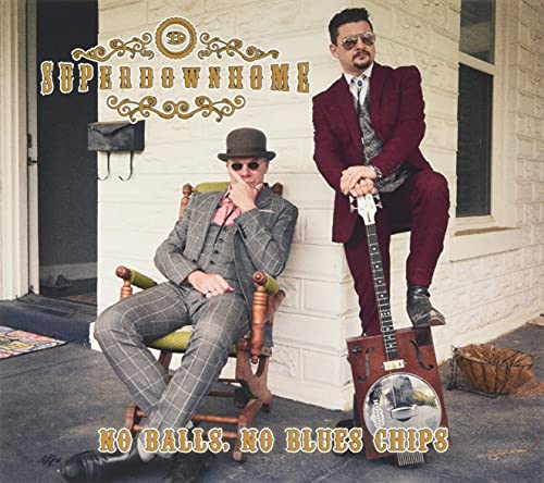 Two men in suits pose with a resonator guitar on a porch.
