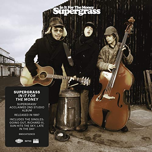 "Album cover featuring three men holding instruments, standing near a trash can."