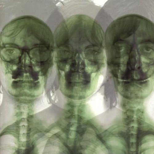 Green-tinted, repeated portrait of a man with glasses, resembling an X-ray.