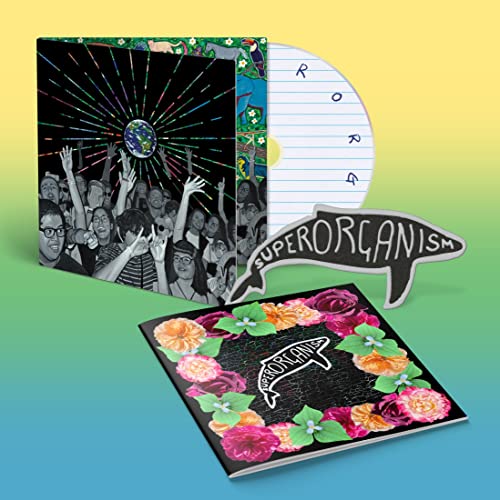 Superorganism CD with colorful artwork, a whale-shaped insert, and floral booklet.