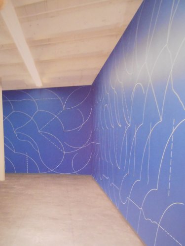 Blue walls with white linear wall drawing by Sol LeWitt.