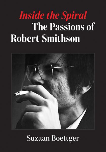Black and white portrait of Robert Smithson smoking a cigarette.